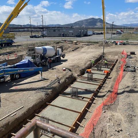 Concrete being poured into trench foundations