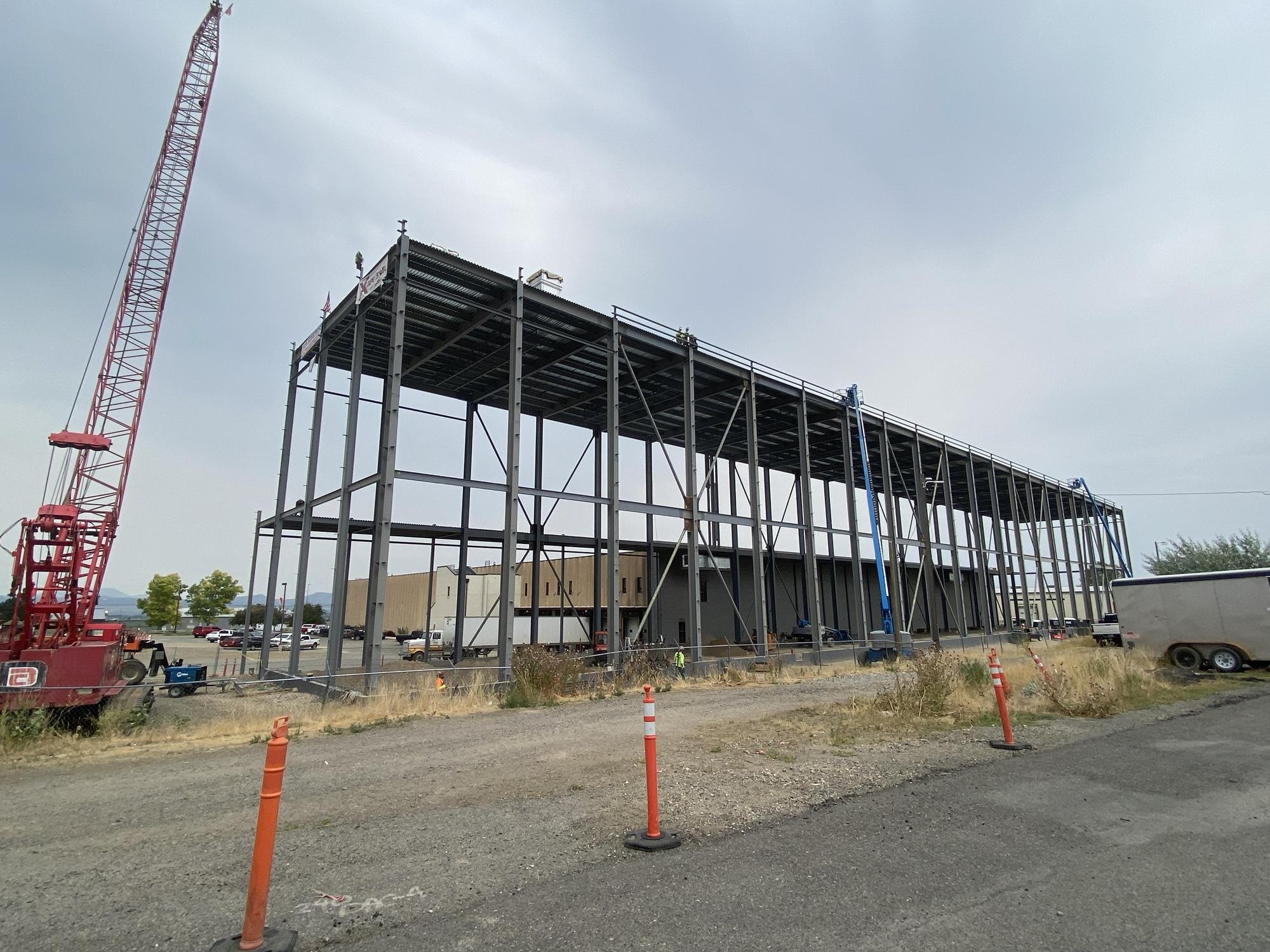  A side view of a large, elevated steel structure at the warehouse under construction.