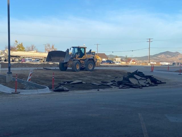 A large construction vehicle removing asphalt