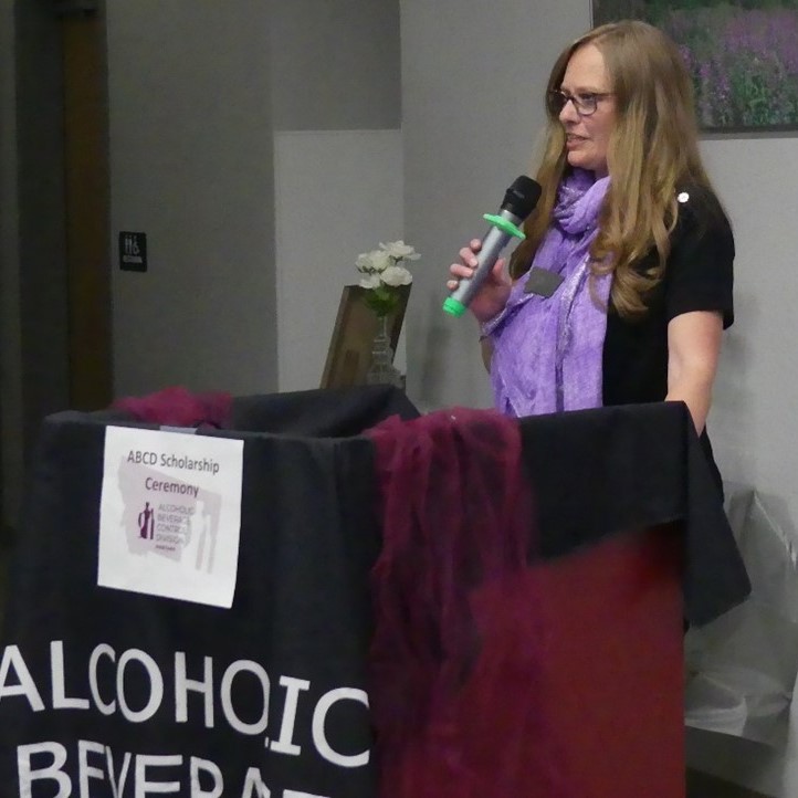 ABCD Administrator Becky Schlauch speaking at a podium